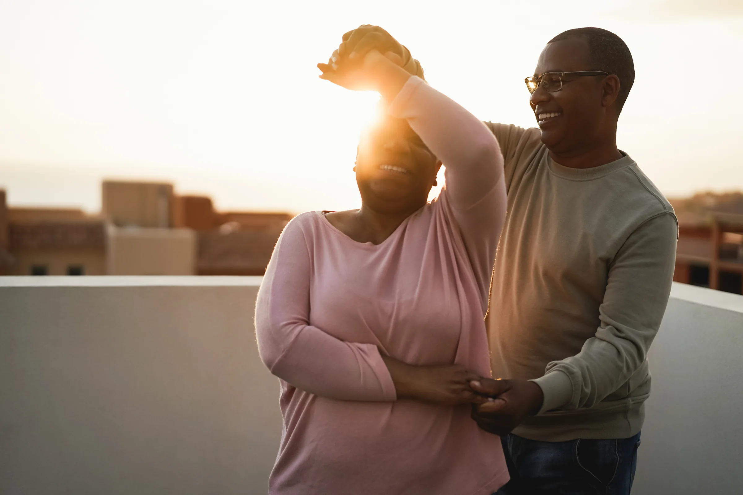 A couple dancing outdoors at sunset