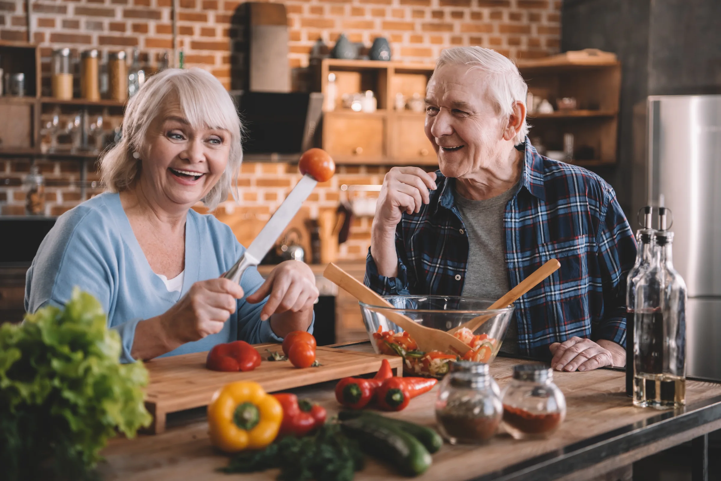 A senior couple cooking together at home
