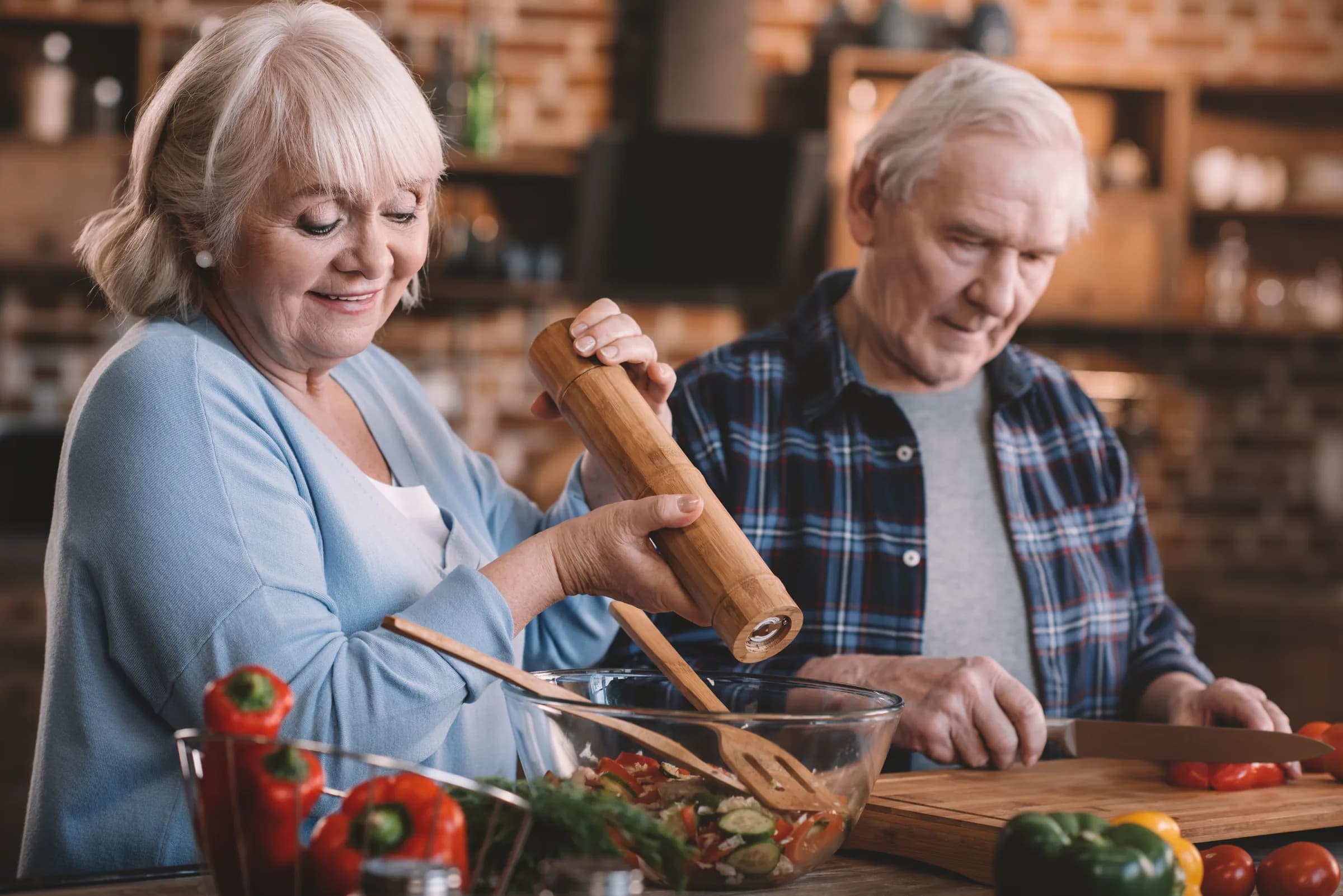 A senior couple cooking together at home